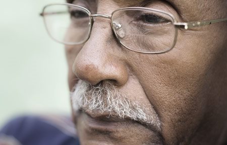 Oudere man met een donkere huid en zichtbare plooien bij neus en lippen