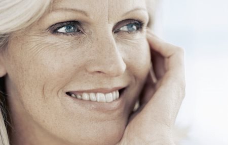 Een lachende vrouw van middelbare leeftijd.